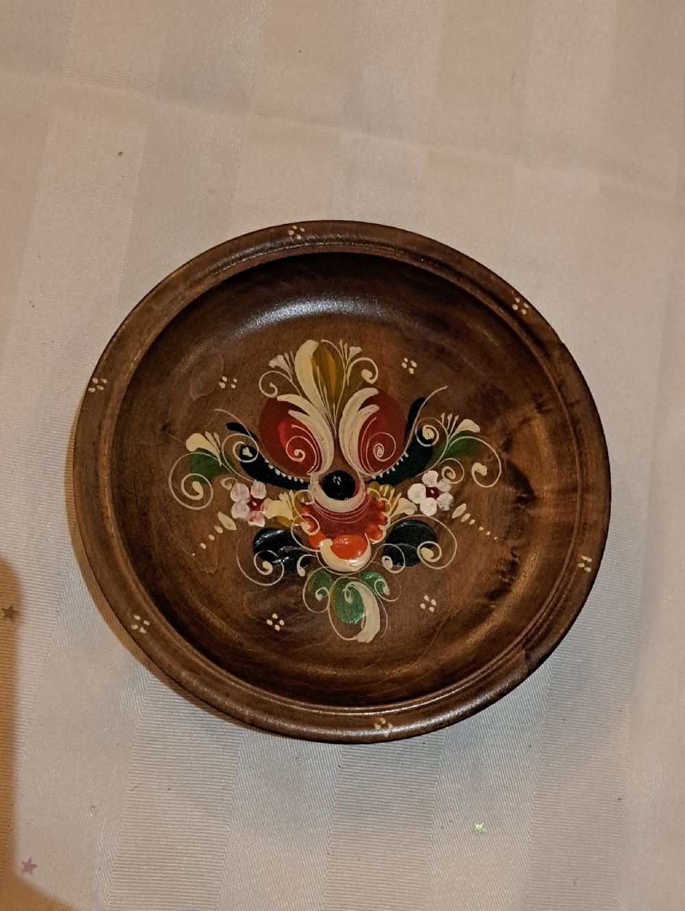 vintage wooden plate featuring colorful German or Scandinavian folk art style